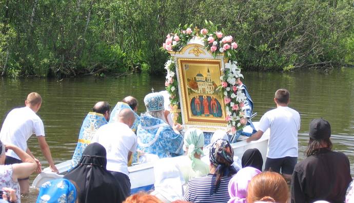 Архиепископ истринский Арсений на лодке выезжает с иконой на Святое озеро.